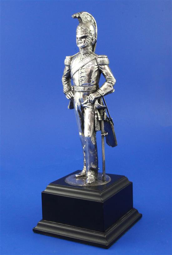 A 1990s silvered model of a soldier in full military regalia,
